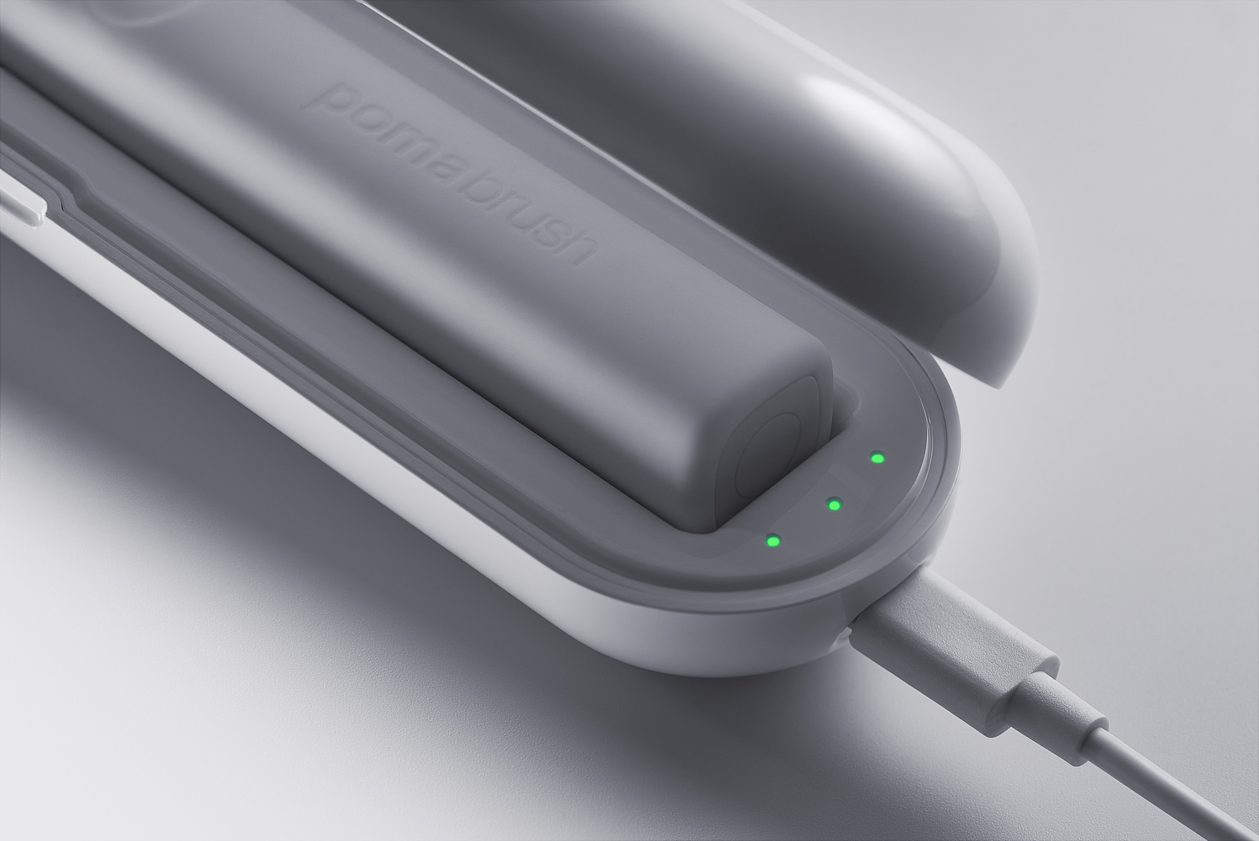 White PomaBrush charging
